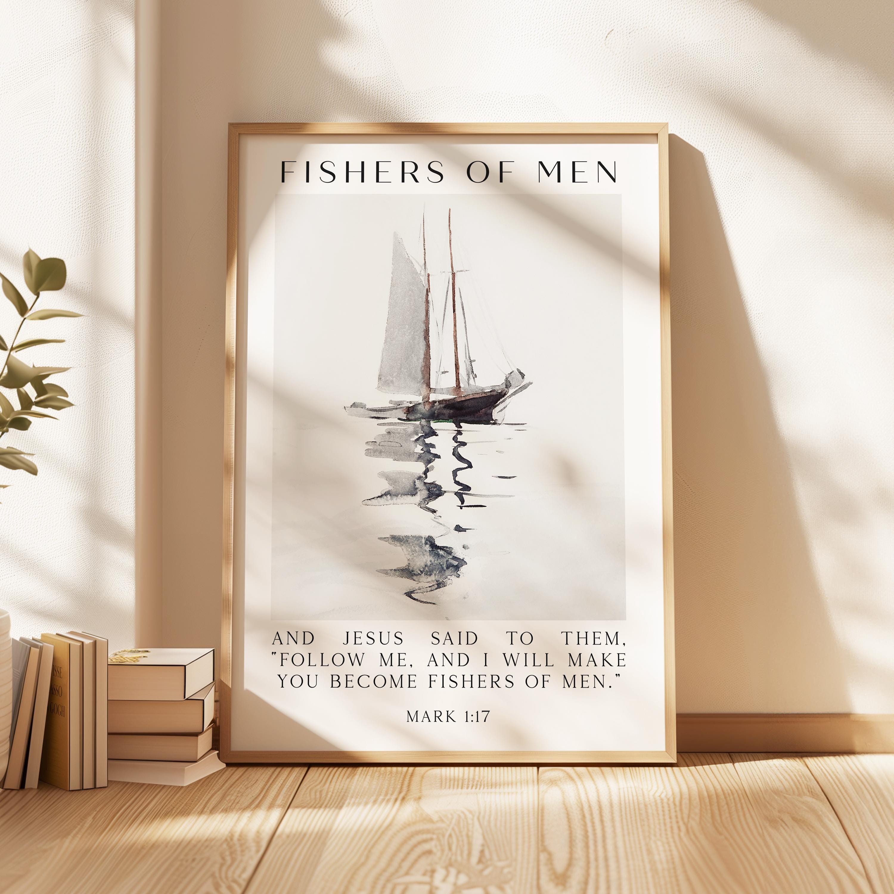 May include: A framed print featuring a watercolor painting of a sailboat on water. The text "FISHERS OF MEN" is at the top, with a Bible verse below. The frame is a light wood color.