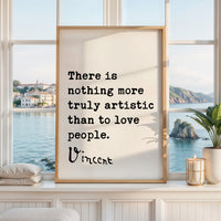 a framed quote by Vincent Van Gogh that reads "There is nothing more truly artistic than to love people." The quote is displayed in a white frame, which is placed on a windowsill overlooking a scenic view of a body of water and a distant island.