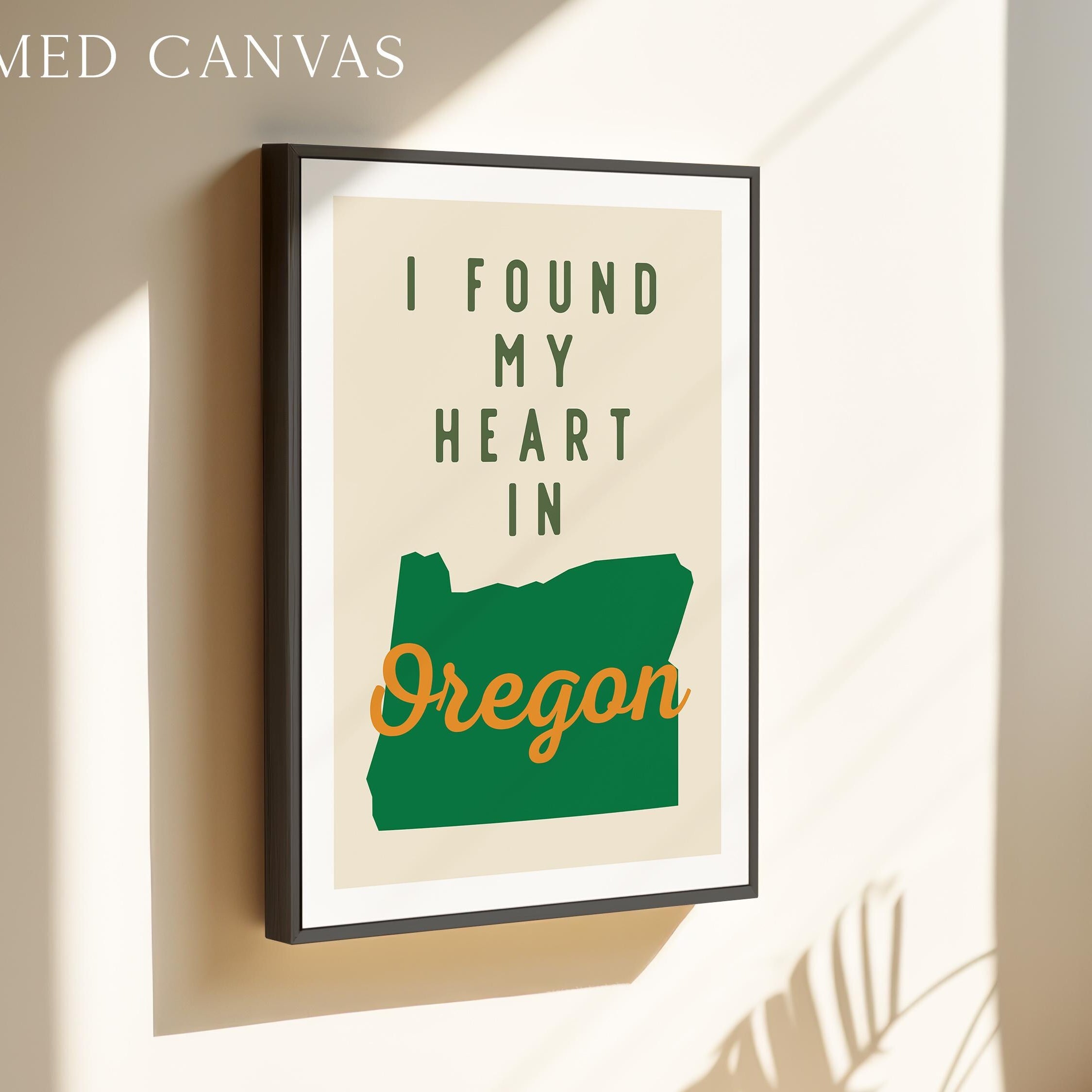 a framed poster with the text "I FOUND MY HEART IN OREGON" and a graphic of the state of Oregon.