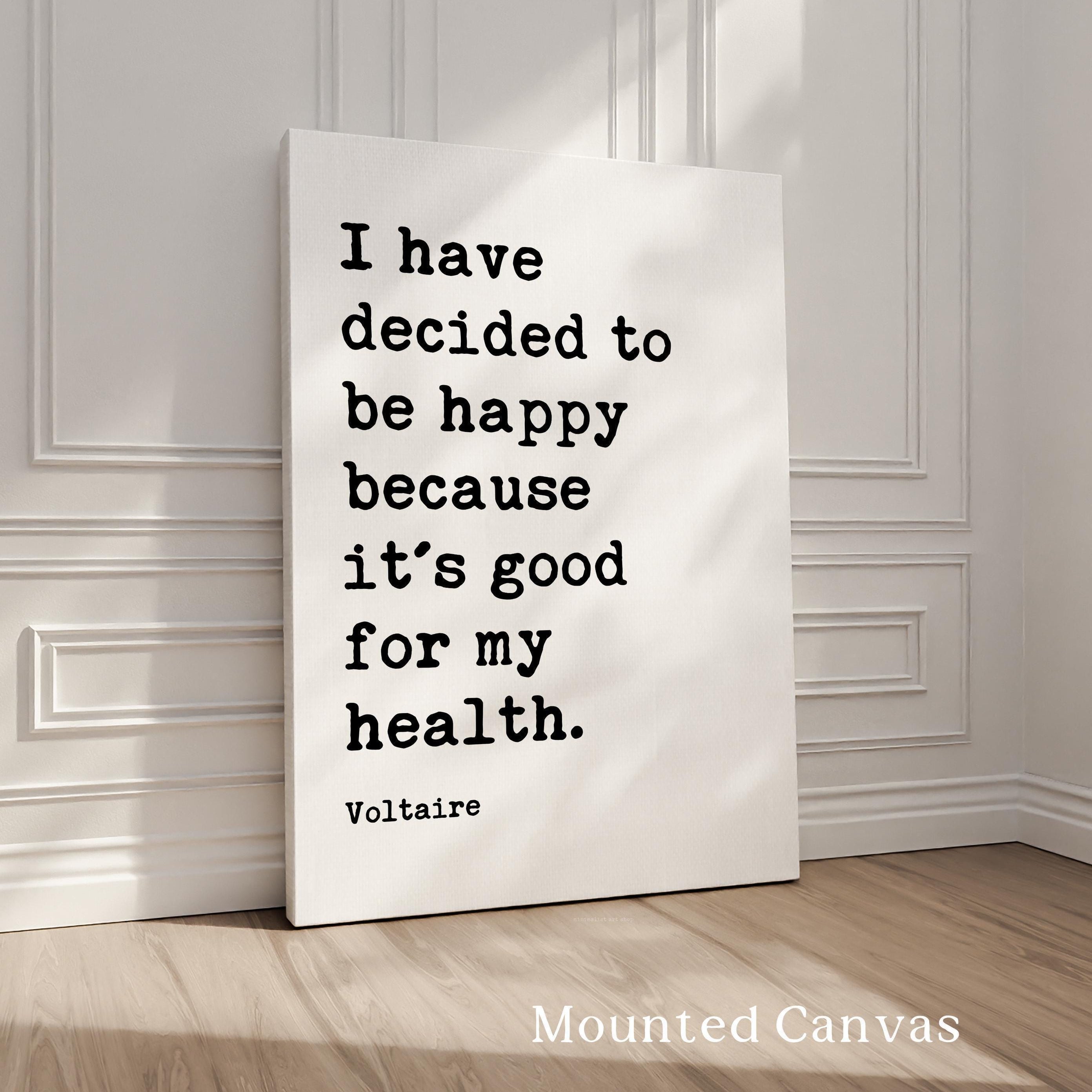 a quote by Voltaire, "I have decided to be happy because it's good for my health," displayed on a canvas.