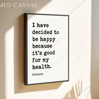 a framed quote by Voltaire that reads, "I have decided to be happy because it's good for my health."