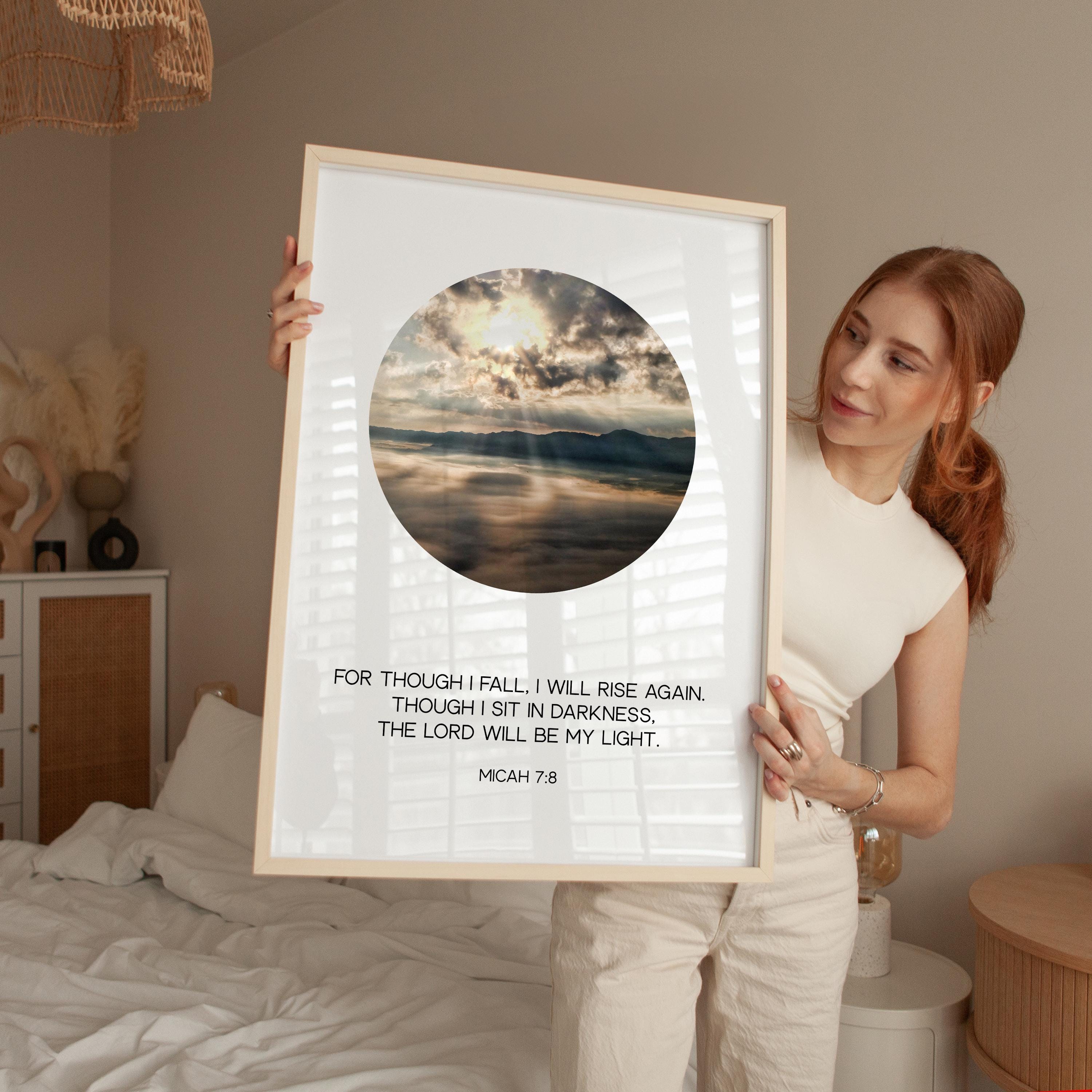 a woman holding up a framed picture with a quote