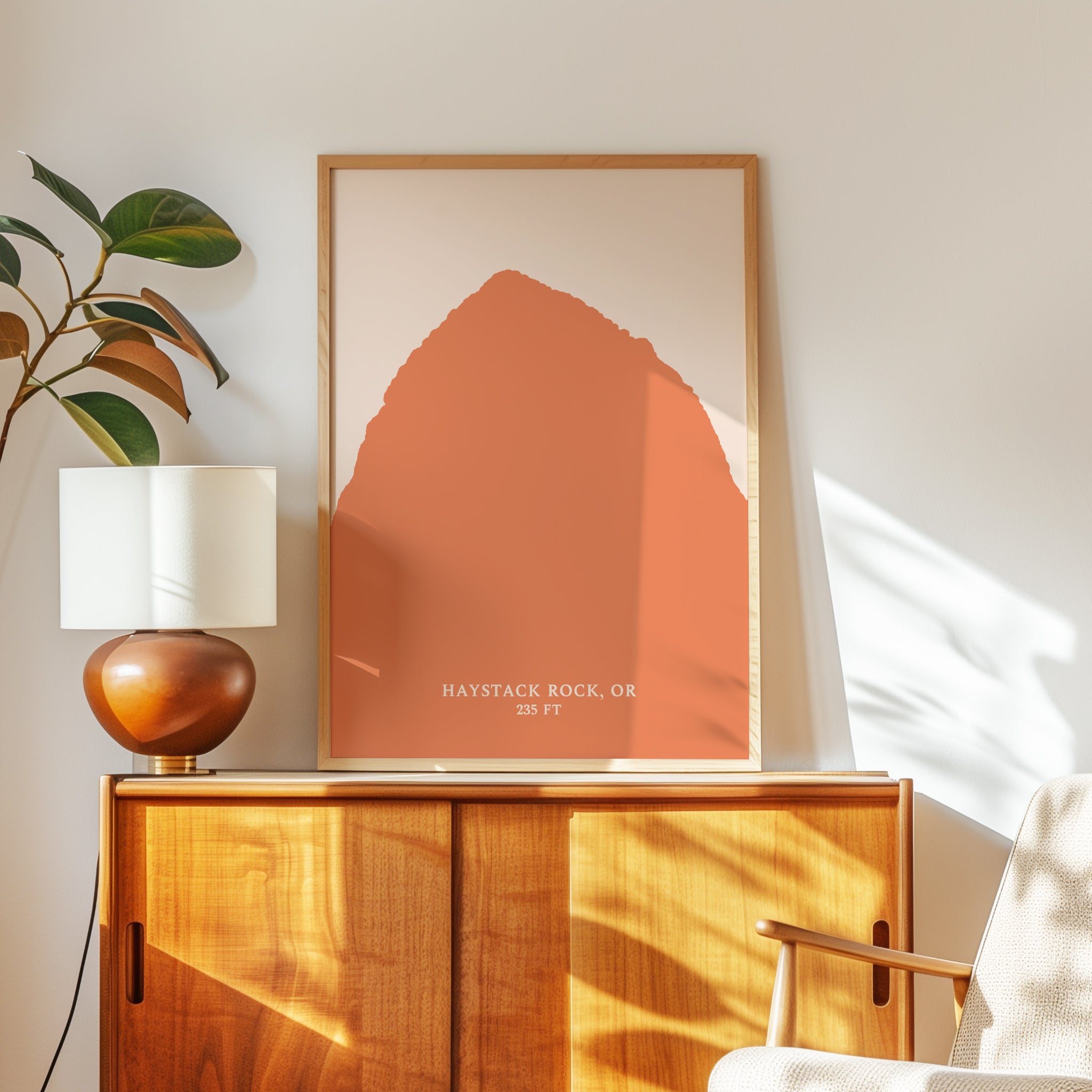 a wooden cabinet with a lamp on top, and a framed artwork of a large orange shape hanging on the wall above the cabinet.