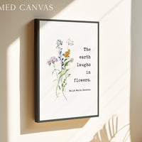 The image is a framed canvas with a quote about the earth laughing in flowers, attributed to Ralph Waldo Emerson.
