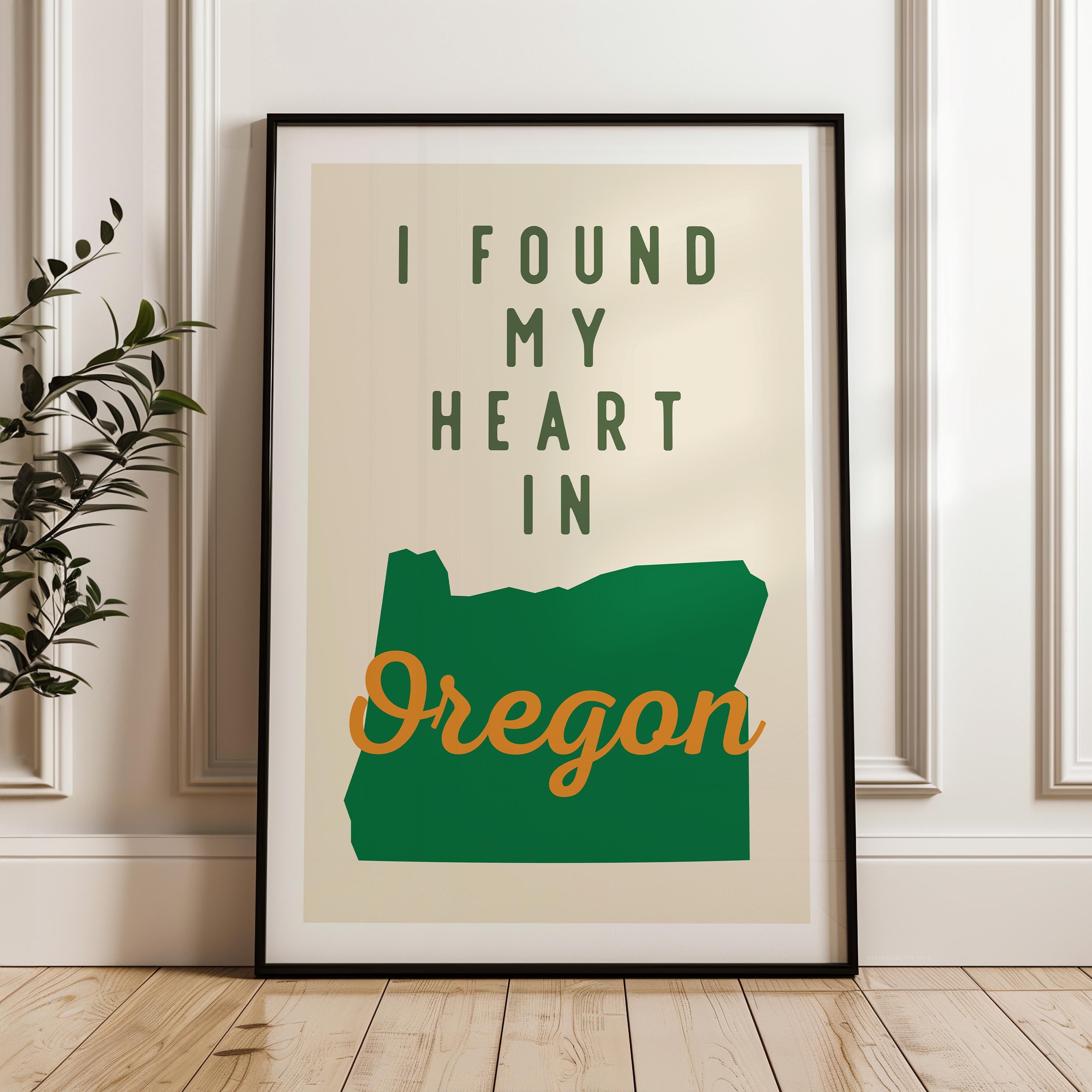 A framed poster with the text "I FOUND MY HEART IN OREGON" and a graphic of the state of Oregon.
