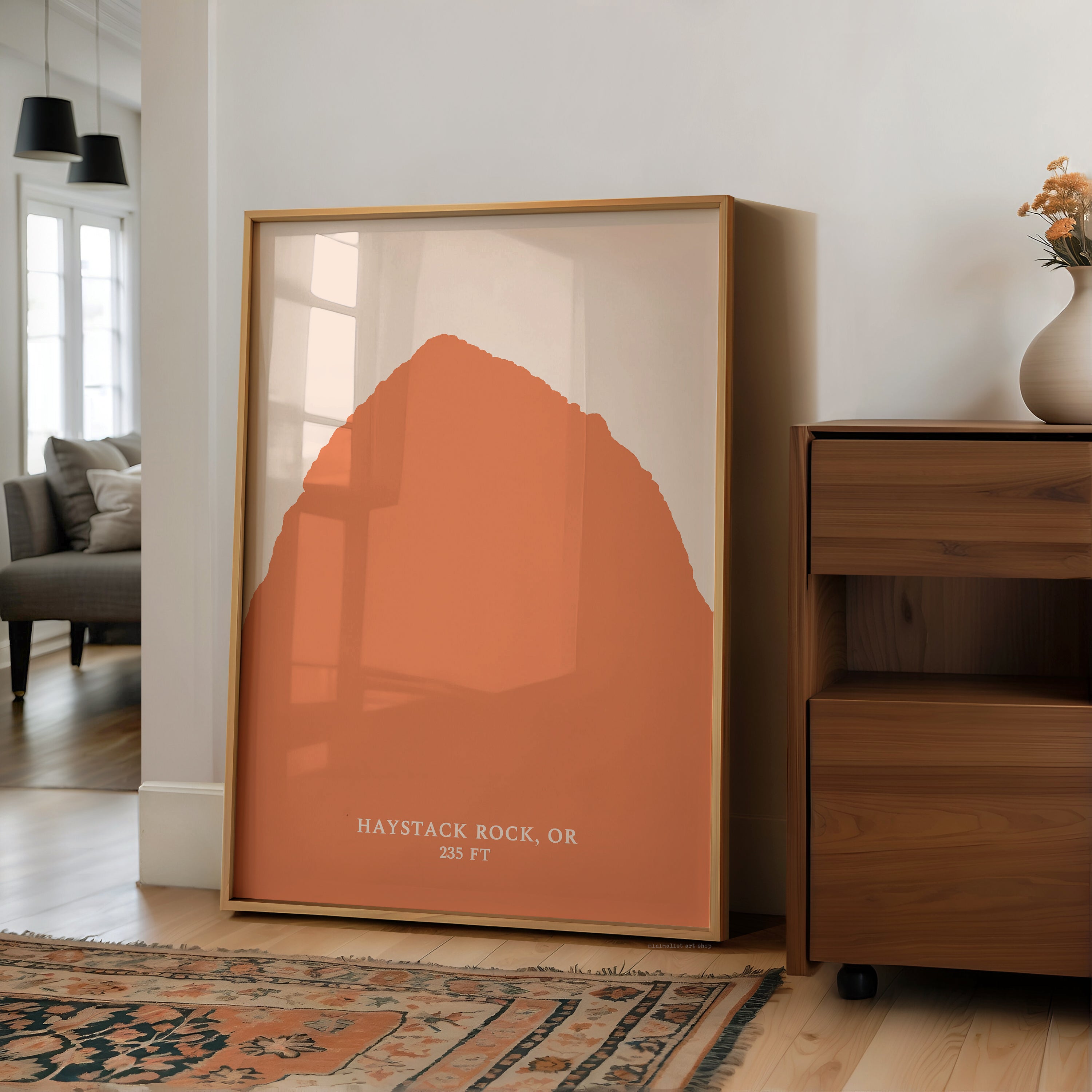 a large framed print of a mountain landscape, with the text "HAYSTACK ROCK, OR" and "25 FT" printed on it.