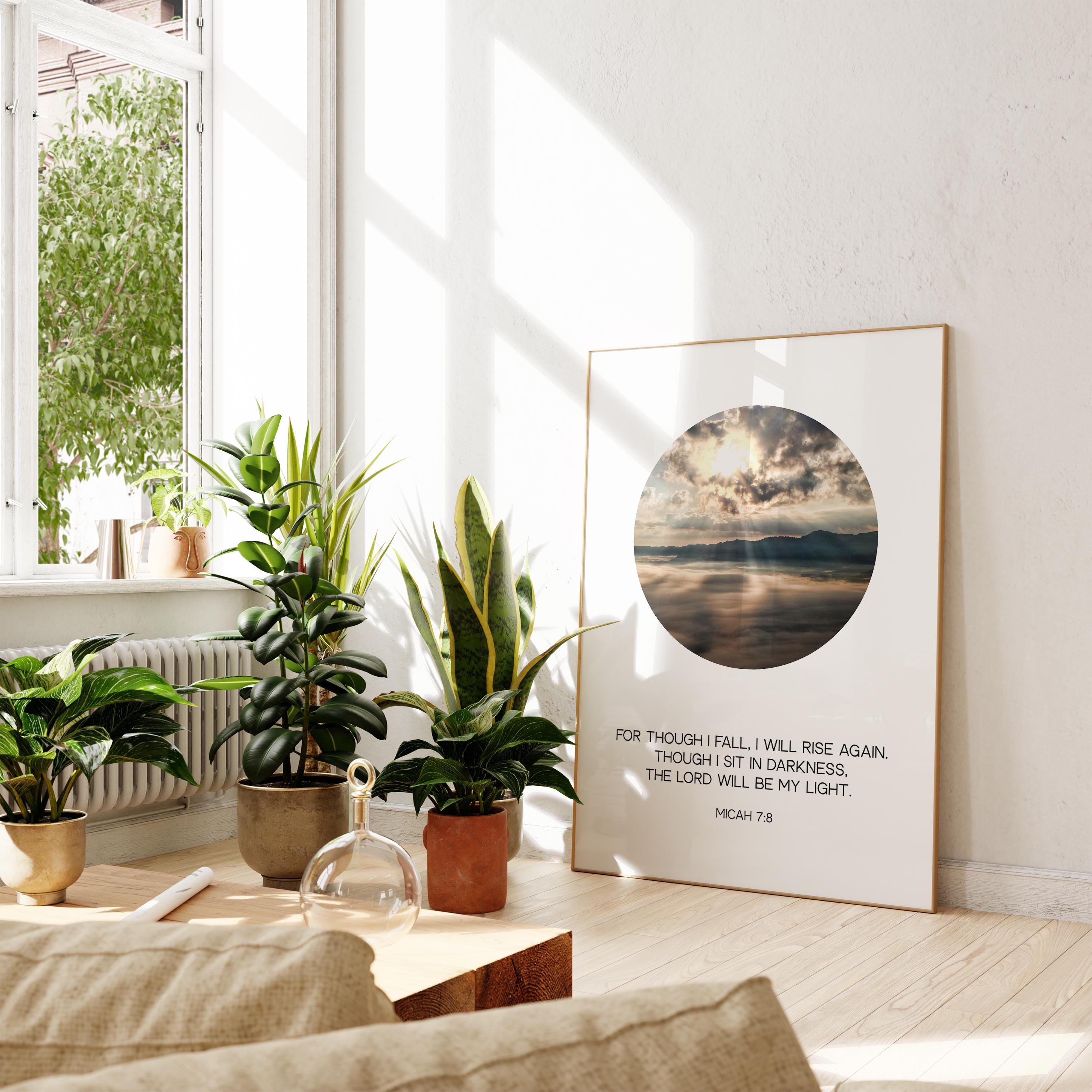 a living room with plants and a picture on the wall