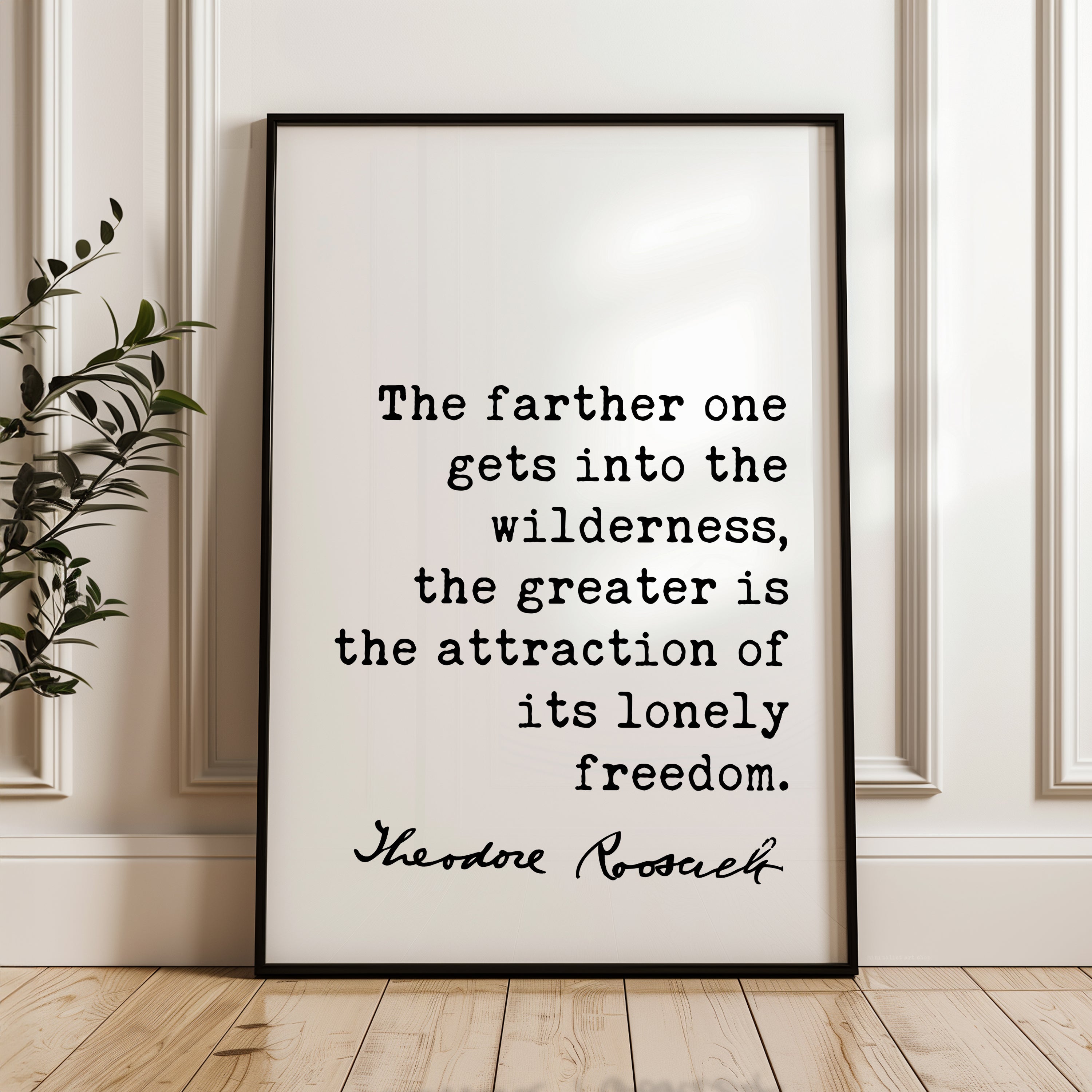a framed quote by Theodore Roosevelt, which reads: "The farther one gets into the wilderness, the greater is the attraction of its lonely freedom."