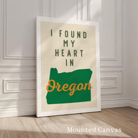 A framed poster with the text "I FOUND MY HEART IN OREGON" and a graphic of the state of Oregon.
