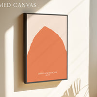 a framed canvas with an abstract orange shape, hanging on a wall.