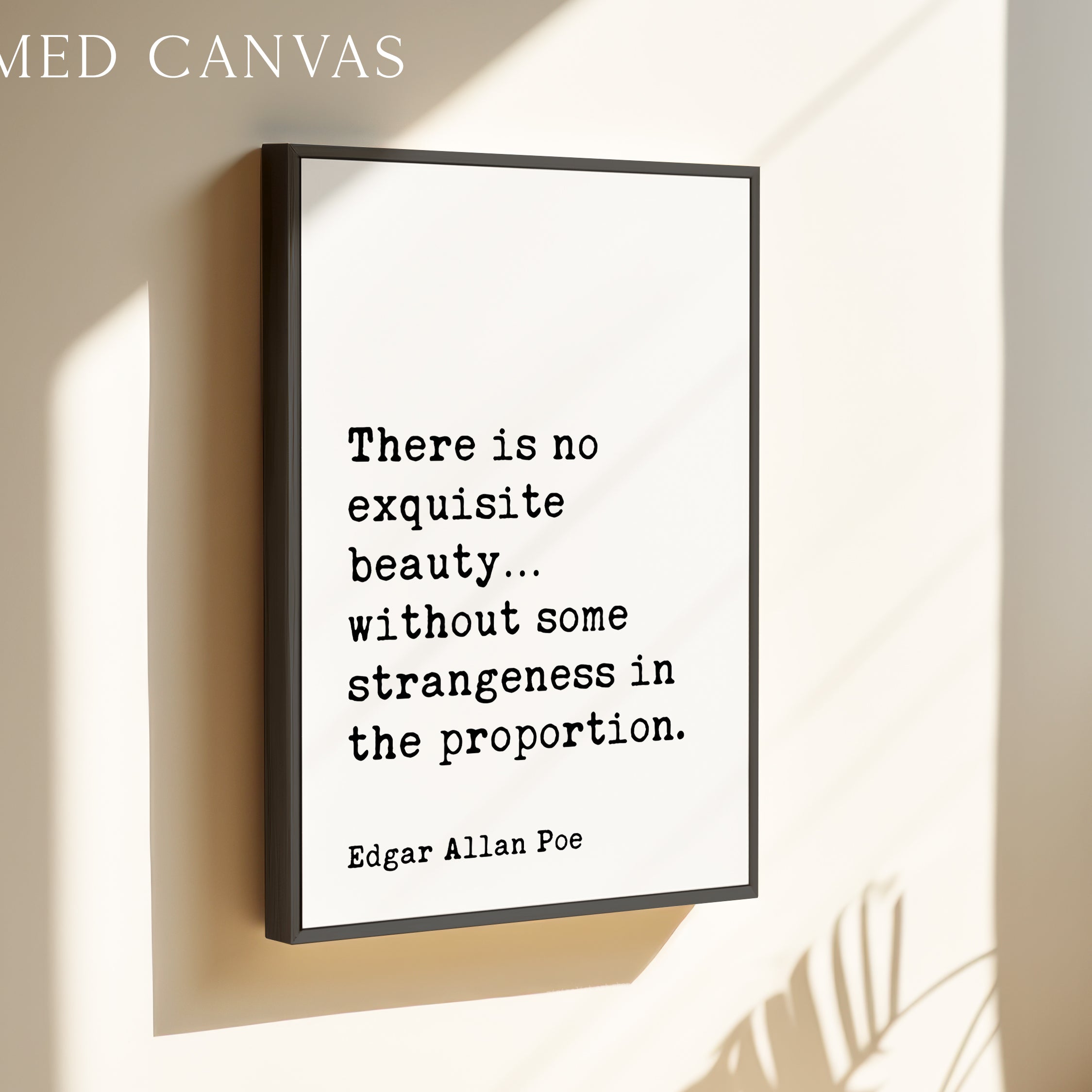 a framed quote by Edgar Allan Poe that reads, "There is no exquisite beauty... without some strangeness in the proportion."