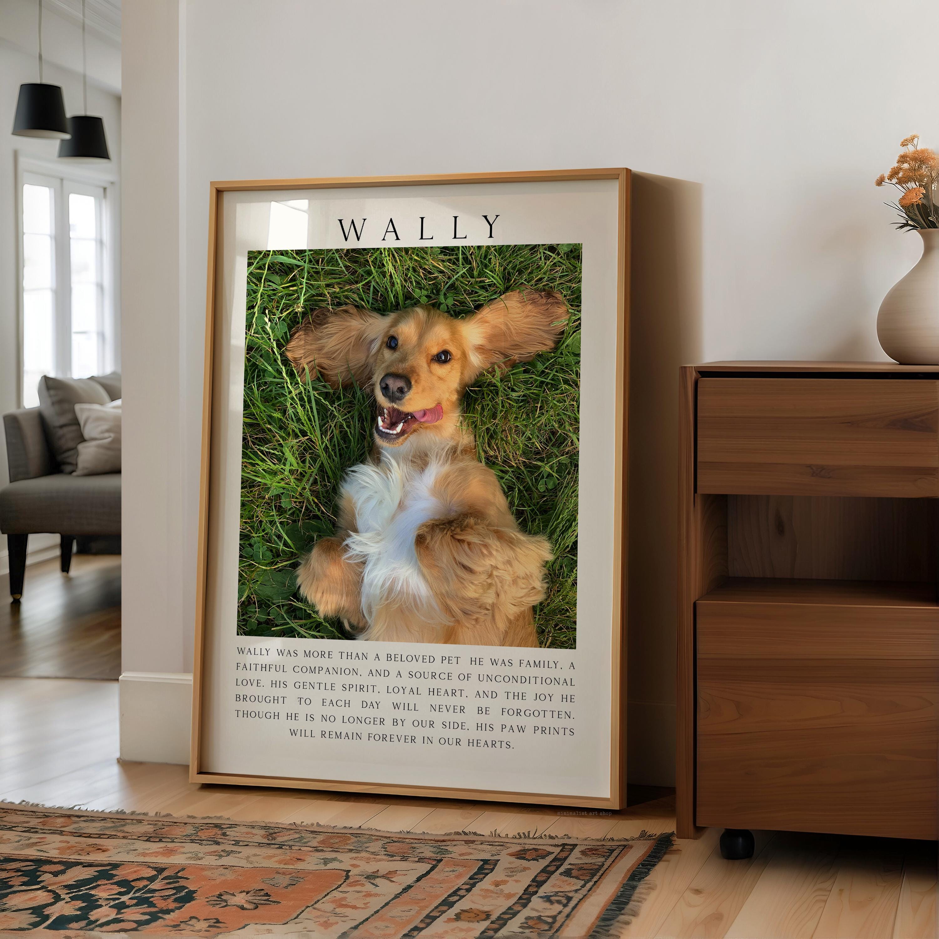 A framed photograph of a dog lying on grass, with a caption that reads "Wally was more than a beloved pet. He was family, a loving companion, and a source of unconditional love and the joy he brought to our lives. Through him, we learned to live without the dog prints he left behind. Will remain forever in our hearts."