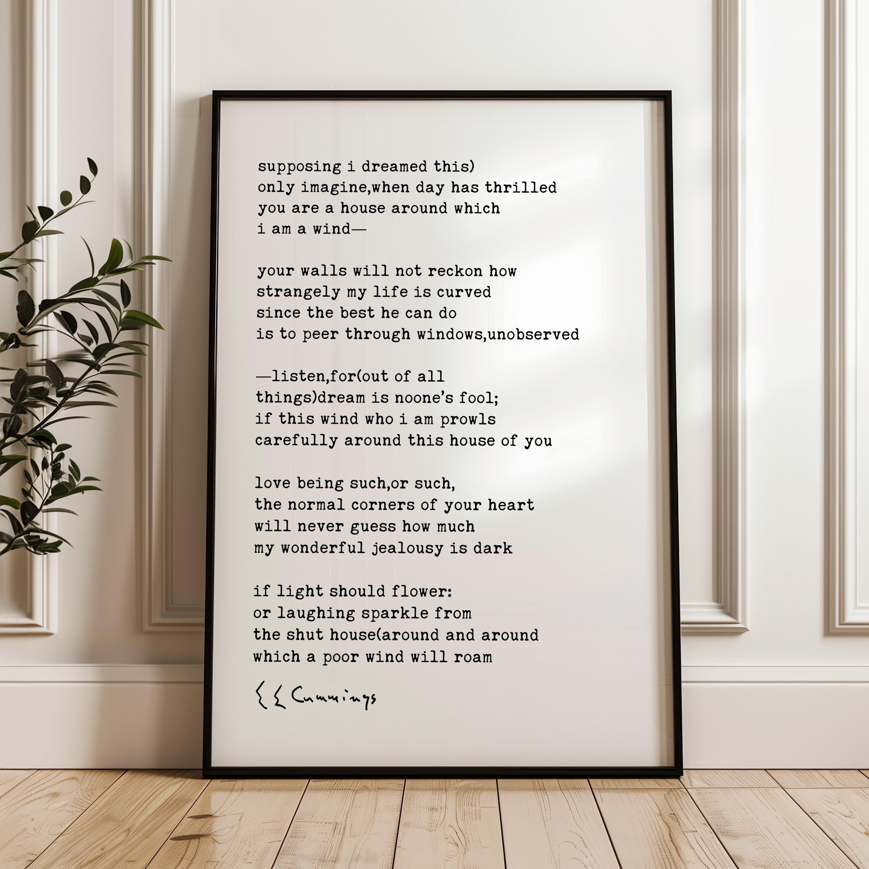 a framed text on a wall, with a plant in the background.