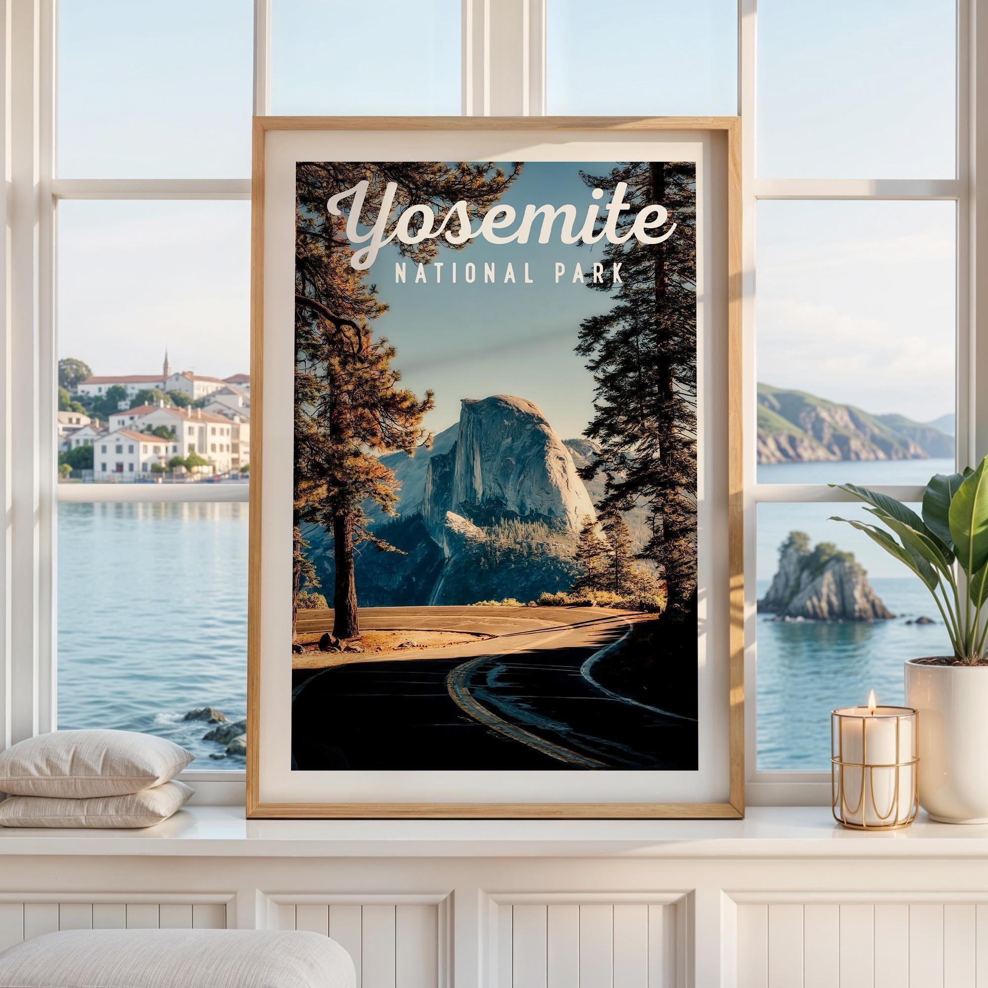 May include: A framed vertical poster featuring a landscape illustration of Yosemite National Park with Half Dome in the background, framed by tall pine trees and a winding road in the foreground. The text Yosemite National Park is printed in white.