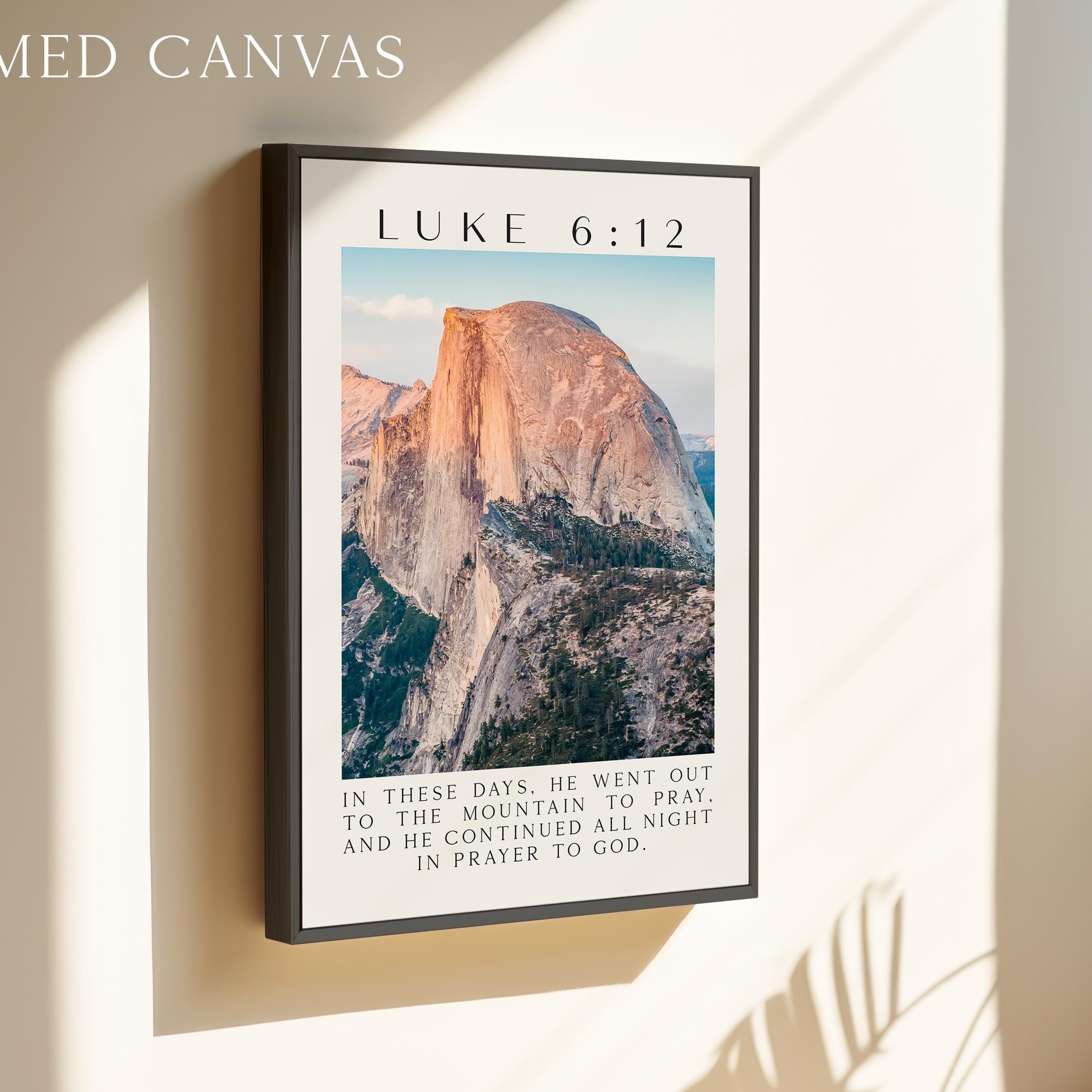 The image is a framed canvas depicting a mountain landscape with a text overlay that reads "In these days, he went out to the mountain to pray, and he continued all night in prayer to God".