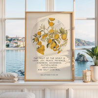 May include: A framed wall art print featuring a circular illustration of orange fruit on leafy branches. Below the illustration, the text reads: THE FRUIT OF THE SPIRIT IS LOVE, JOY, PEACE, PATIENCE, KINDNESS, GOODNESS, FAITHFULNESS, GENTLENESS, AND SELF-CONTROL. GALATIANS 5:22-23.