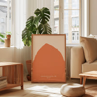a living room with a large orange abstract painting on the wall, a large potted plant, a wooden coffee table, and a beige sofa.