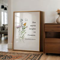 a framed quote by Ralph Waldo Emerson that reads "The earth laughs in flowers."
