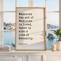 May include: A rectangular framed wall art piece featuring a white background with black typewriter-style text that reads: Wherever the art of Medicine is loved, there is also a love of Humanity. The name Hippocrates is printed below the quote.
