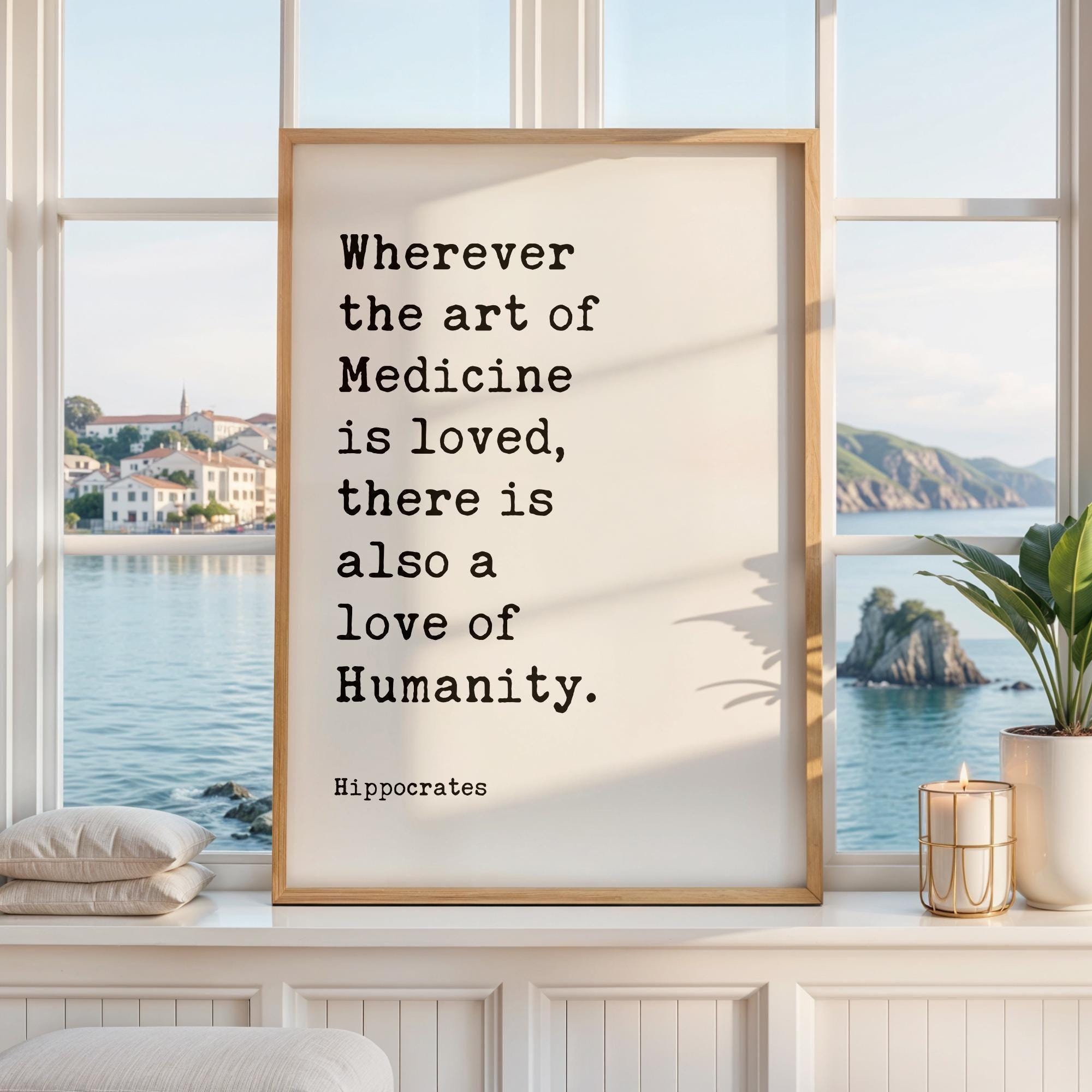 May include: A rectangular framed wall art piece featuring a white background with black typewriter-style text that reads: Wherever the art of Medicine is loved, there is also a love of Humanity. The name Hippocrates is printed below the quote.