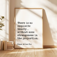 a quote by Edgar Allan Poe, "There is no exquisite beauty without some strangeness in the proportion." The quote is displayed in a framed format on a wooden surface, with a stack of books and a plant in the background.