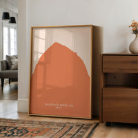 a large framed print of a mountain landscape, with the text "HAYSTACK ROCK, OR" and "25 FT" printed on it.