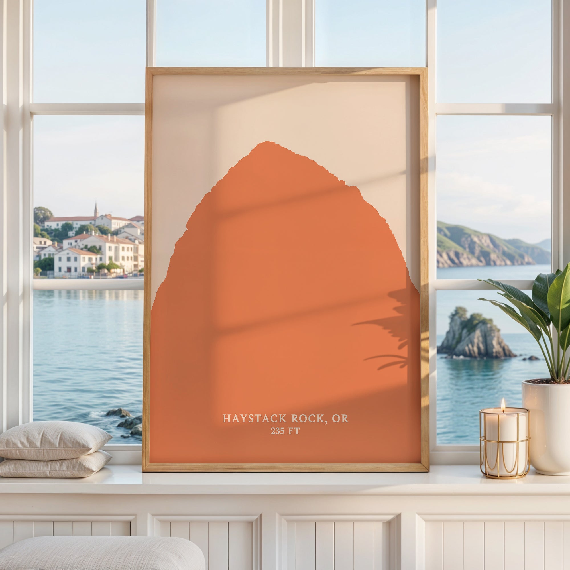 a large orange-colored poster or painting displayed on a window, with a scenic view of a coastal landscape visible through the window.