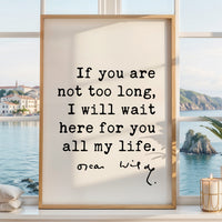 a framed quote by Oscar Wilde that reads, "If you are not too long, I will wait here for you all my life." The quote is set against a scenic view of a body of water and a coastal town, creating a serene and contemplative atmosphere.
