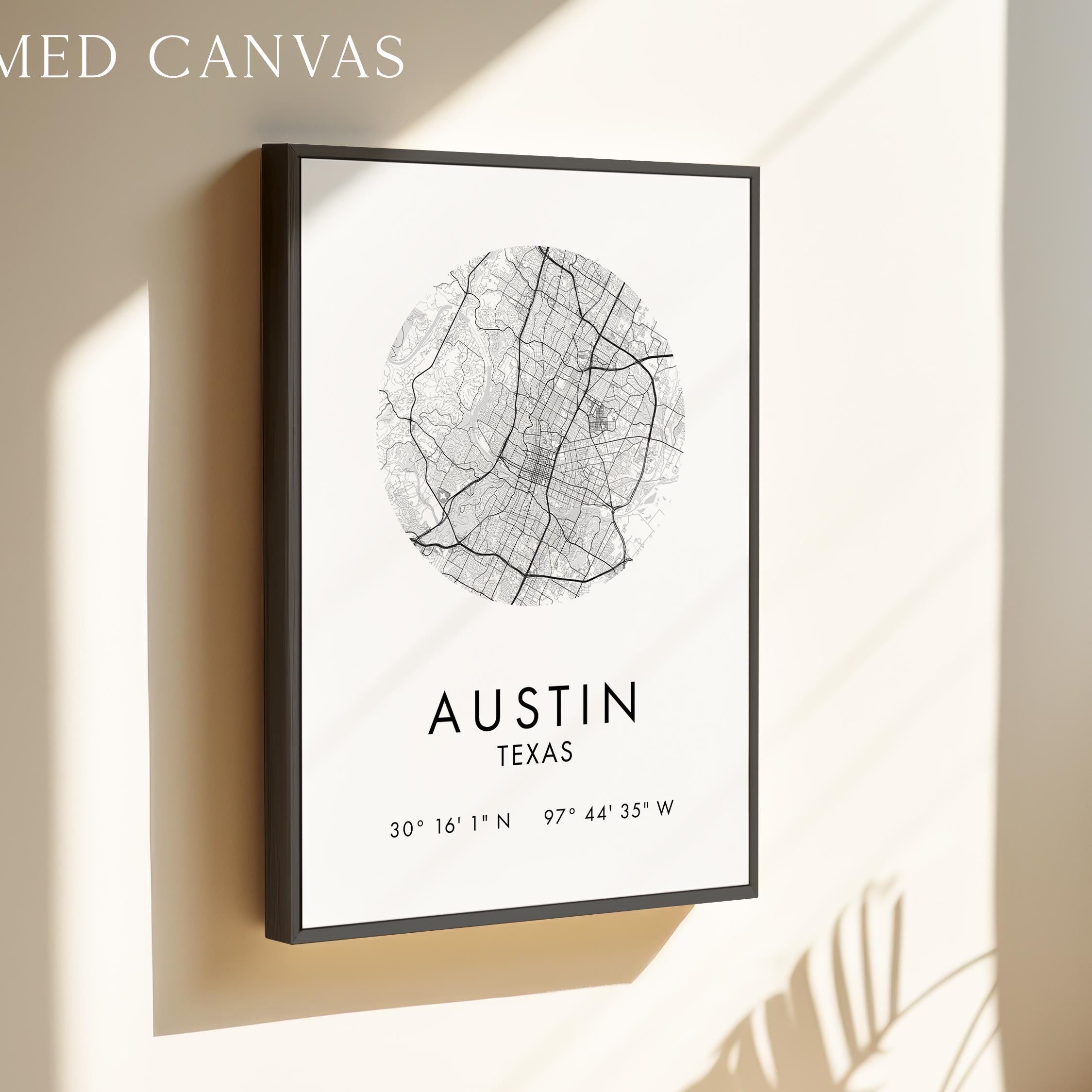 a framed canvas depicting a map of Austin, Texas, with the city's location and compass directions provided.
