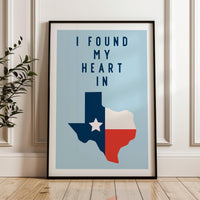 A framed poster with the text "I FOUND MY HEART IN" and a graphic of the state of Texas.